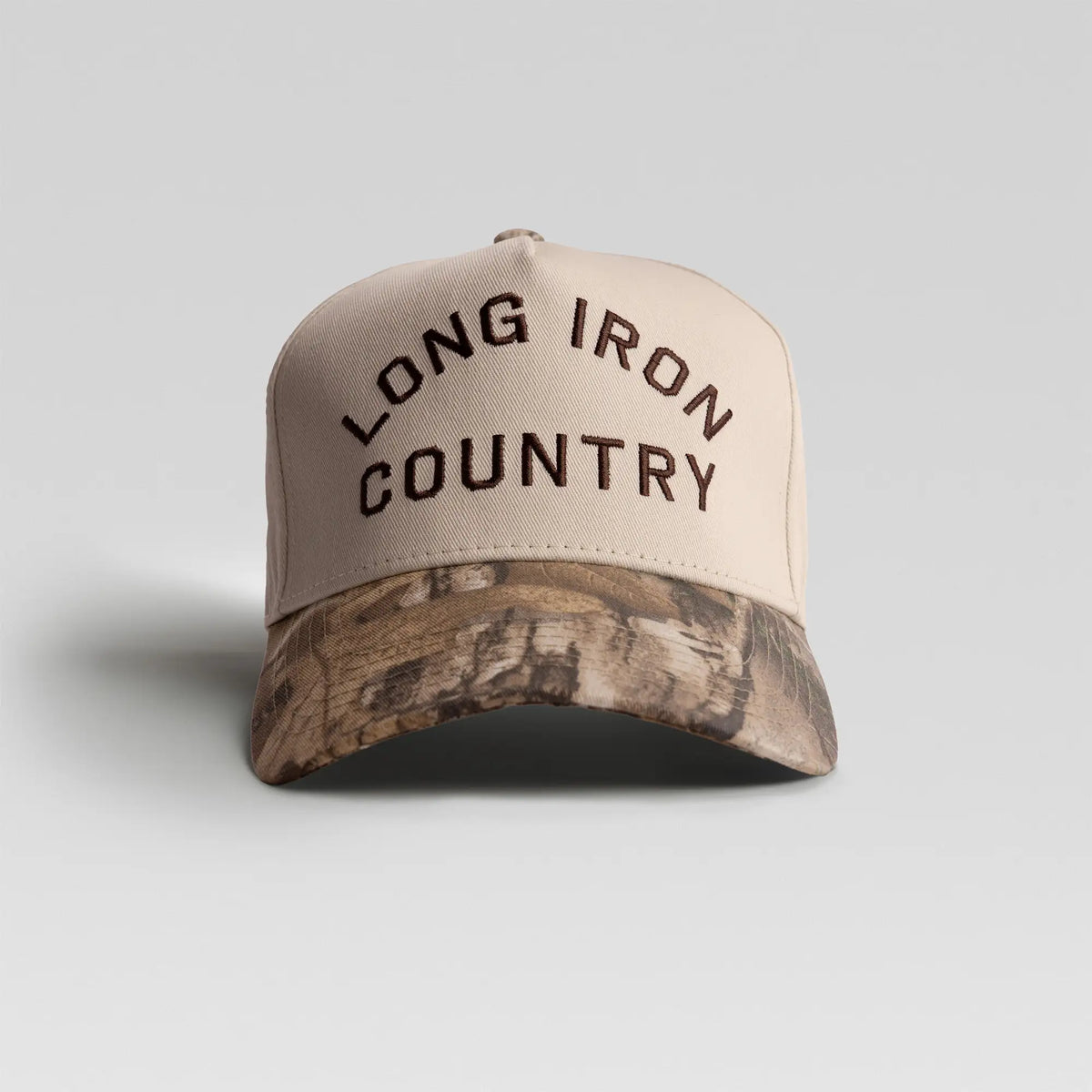BUNX Golf Long Iron Country 5-panel A-frame snapback in natural with camo brim, front view with arched embroidery