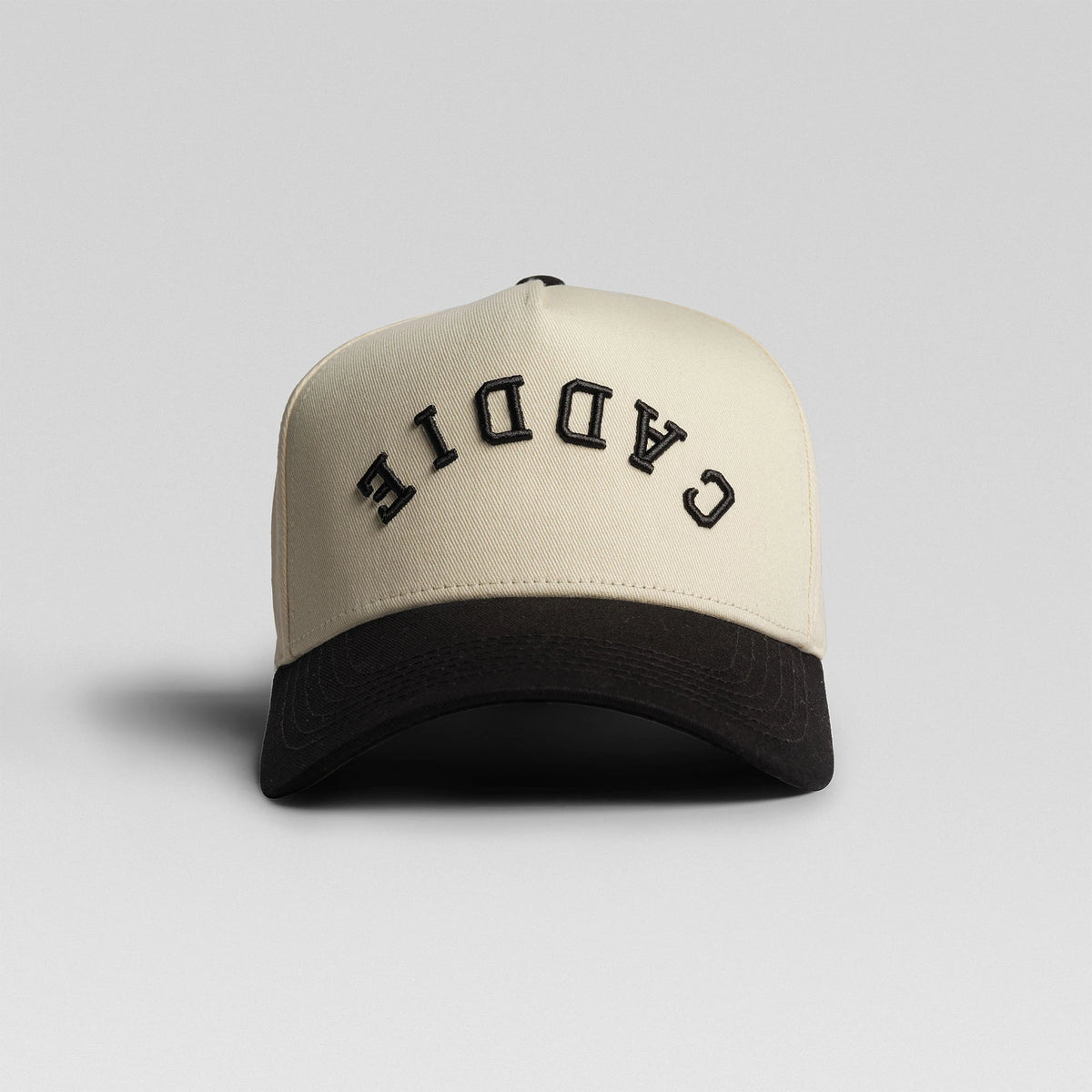 BUNX Golf Caddie 5-panel snapback in natural with black brim, front view with arched text