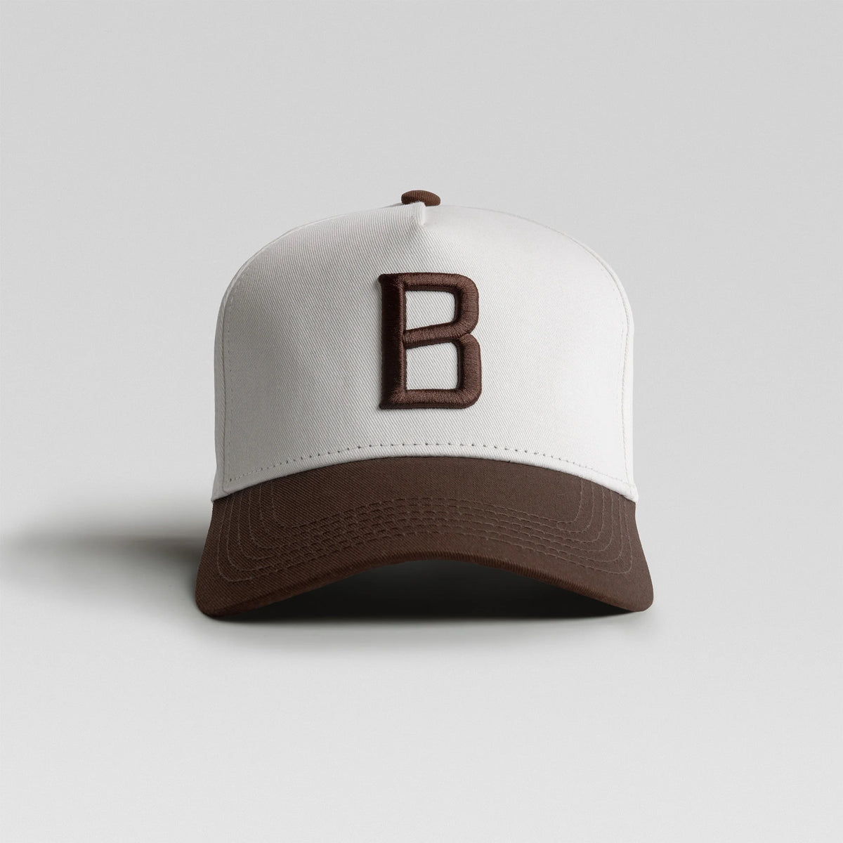BUNX Golf signature B 5-panel snapback in chocolate and white, front view
