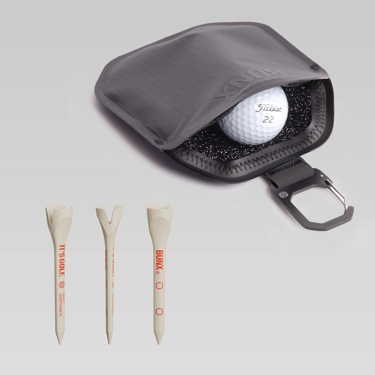 BUNX Golf Scrub Pouch and V-01 tees bundle with black pouch holding a golf ball